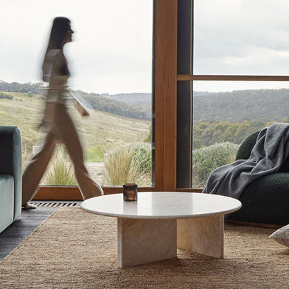 Lady walking thrua living room on beutiful rug