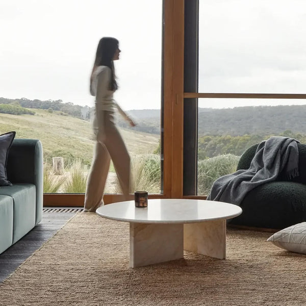 Lady walking thrua living room on beutiful rug
