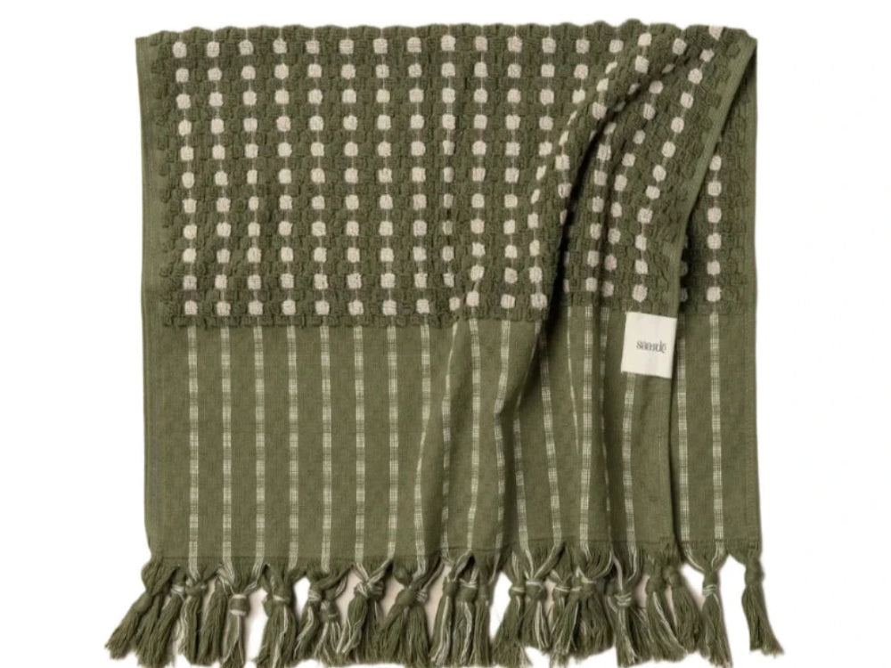 A green and beige striped saarde bath towel with a fringed edge