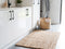 white laundry room with a jute mat on the floor