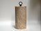 Cylindrical marble light pendant with a black lid on a light gray background